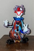 Front view of multicolour Murano glass clown figurine showing peace signs