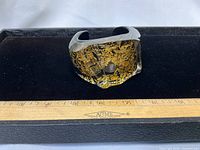 Front view of lucite cuff showing gold leaf pattern