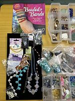 Overview with Beaded Bands book, bead strands, bags of beads in organiser