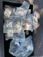 Multiple sealed Richelieu handle bags in tray