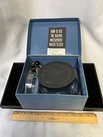 Open case showing tester components and instruction booklet