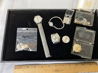 Overview of tray showing all Caravelle watch heads, expansion band, bag and boxes of parts