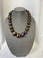 Necklace on display bust showing bead shapes and colors