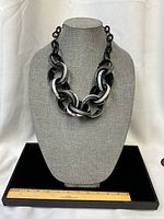 Front view of full necklace on bust displaying link design and scale