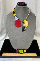 Full set displayed on bust: necklace, bracelet on neck, brooch on tray