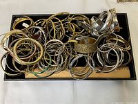 Tray filled with numerous bangles and bracelets