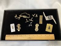 Overall view of all accessories in tray with ruler for scale