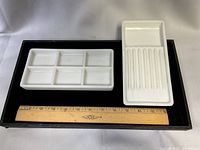 Both porcelain trays on display beside 12-inch ruler for scale