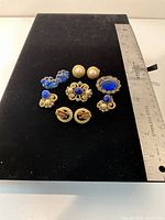 Front view showing all six pairs of earrings with ruler for scale