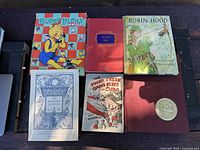 Front covers of six vintage hardcover books laid out on table