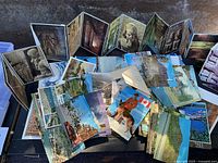 Overhead view of entire lot showing loose postcards and unfolded accordion booklets