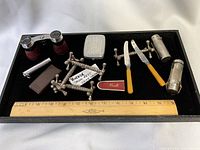 Overall lot with opera glasses, knife rests, cigarette case, spreaders, match safes, ruler
