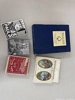 All items laid out: blue giant card box, three decks, magnet pack