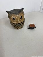 front view of ceramic owl lantern and separate candle holder