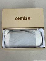 Speaker in original box with lid open showing protective wrap