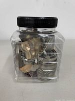 Front view of jar showing assorted bracelets