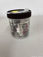 Gelato pint container filled with assorted earrings, side view showing nutrition label and contents