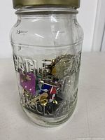 Front view of mason jar filled with assorted costume jewelry