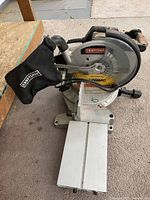 Overall view of Craftsman 10" compound miter saw showing dust bag and extension arm
