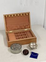 Group shot showing jewelry box open with interior, glass jar, metal dish, lacquer box and blue tray
