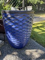 Blue glazed planter front view showing texture and height