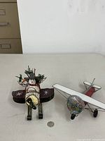 Both airplane figurines shown together with coin for scale
