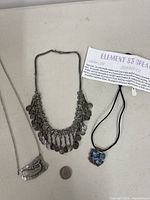 All three necklaces with quarter for scale
