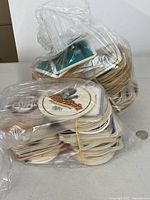 Two plastic bags filled with stacked beer coasters