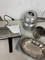 All items grouped: waffle iron, double boiler, tray, sifter