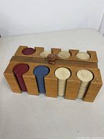 Angled top view showing wooden caddy loaded with cream, blue and red chips