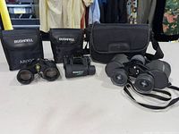 Group shot of all three binoculars with their respective cases.