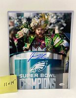 Full view of signed 11"x14" photo in sleeve with 11x14 note visible