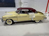 Driver side view of model showing body color, roof color, wheels and packaging