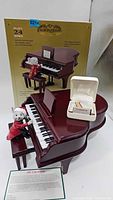 Overall view of piano music box, mouse figure, song card box, and original package
