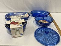 All items laid out: mixing bowls stack with sleeve, 2-pc value pack rectangular dishes, round casserole, lid