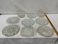 All nine pressed glass pieces in 3×3 layout