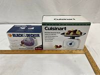 Front view of boxed Black & Decker HandyChopper Plus HC3000 and boxed Cuisinart Precision Gourmet kitchen scale