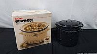 Boxed Rival Crock-Pot beside enamelware pot