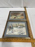 Both framed prints side by side with ruler for scale