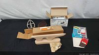 Full lot view with wooden anvil, iron shoe parts, pocket and patch packages