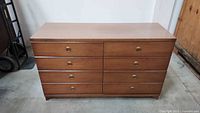 Front view of six-drawer chest showing drawers and brass pulls