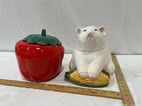 Pig on corn and red pepper cookie jars with ruler for scale