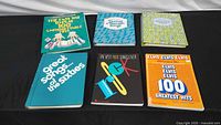 All six songbooks laid out showing front covers