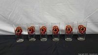 six Redskins logo glasses lined up