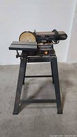 Front view showing Craftsman belt/disc sander on stand