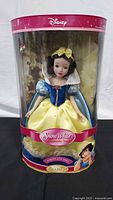 Front view of boxed Disney Snow White porcelain doll