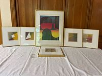 All six framed prints displayed; central large piece and five smaller