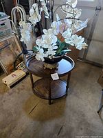 Table with orchid arrangement placed on top