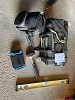 Overview showing BRICO toolbox, hammer, level, pouch, small case