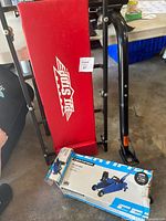 Overview showing creeper, bike rack upright, trolley jack box